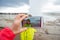 Mother recording video of her preschool son, boy enjoying the eruption of Strokkur Geysir in Iceland