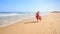 Mother in Red Little Girl Join Hands Run by Foamy Surf