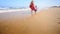 Mother in Red Little Girl Join Hands Run by Foamy Surf