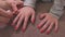 Mother removes nail varnish from daughter hand