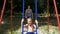 Mother Ride her Little Son on a Street Swing at Playground in Slow Motion