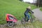 Mother riding a E-Bike with child trailer