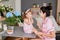 Mother`s day greeting card. Family mother and baby daughter in morning have breakfast in kitchen. Spring card for Women`s Day