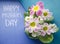 Mother`s day greeting concept. Floral background with primrose flowers. Delicate primula flowers on a blue and turquoise backgroun