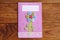 Mother`s day or Mom birthday greeting card with flower isolated on a wooden background. Easy handmade card to make in school