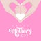 Mother\\\'s day mother\\\'s hands hold the legs of the smal children she loves in pink and white colors