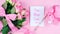 Mother`s Day overhead with roses, Best Mom Ever card and gift on pink table.