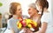 Mother`s day! three generations of  family mother, grandmother and daughter congratulate on the holiday, give flowers