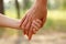 Mother`s hand lead her child in forest, trust family concept