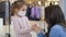 Mother sanitizing her daughter`s hands with antibacterial hand spray.