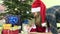 Mother with Santa hat with infant daughter in christmas dress