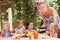 Mother Serving Birthday Cake To Group Of Children