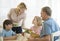 Mother Serving Food To Family At Table