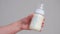 Mother shakes transparent bottle with baby infant formula