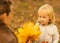 Mother showing baby fallen leaves