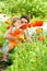 Mother showing flowers to daughter