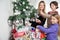 Mother And Siblings Decorating Christmas Tree