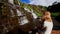 Mother Sits Holds on Knees Little Girl Makes Selfie by Waterfall