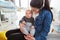 Mother sits in the living room with baby in her arms