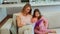 Mother sitting on the sofa with her daughter