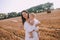 mother small daughter white dresses field straw