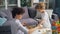 Mother and small son placing chess pieces on chessboard playing at home at table