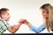 Mother and son arm wrestling.