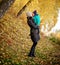 Mother with son in autumn peach garden