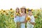 Mother, son and baby daughter in sunflowers field.Children Protection, mothers and Fathers Day. Family Summer vacation traveling.