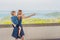 Mother and son in the background of Tropical beach landscape panorama. Beautiful turquoise ocean waives with boats and sandy coast