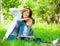 Mother and son with book cover eyes in park