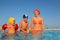 Mother with son and daughter sitting in pool