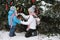 Mother and son decorate the Christmas tree outdoor in a winter park. Gifts and Christmas trees.