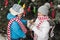 Mother and son decorate the Christmas tree outdoor in a winter park. Gifts and Christmas trees.