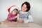 Mother and son decorating the gingerbread cookies