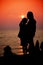 Mother and son in a deep moment of love during sunset at beach