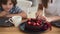 Mother and son enjoy festive dessert lady cuts cake slices