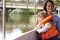 Mother And Son Enjoying Day Out In Boat On River Together