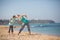 Mother with son exercising on the beach