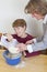 Mother and son having fun in kitchen