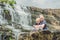 Mother and son hikers, tourists on the background of Amazing Pongour Waterfall is famous and most beautiful of fall in Vietnam. N