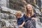 Mother and son hikers, tourists on the background of Amazing Pongour Waterfall is famous and most beautiful of fall in Vietnam. N