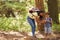 Mother With Son Hiking Or Walking Through Woodland Countryside