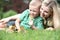 Mother and son lying on grass and looking like a little duck walk