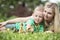 Mother and son lying on grass and looking like a little duck walk