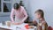 Mother and son are making christmas gingerbread cookies from dough at home.