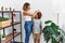 Mother and son measuring child height drawing mark on wall at home