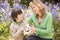 Mother and son outdoors holding ball smiling