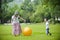 Mother and son play ball in grass