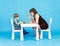 Mother and son play chess. Family and education concept